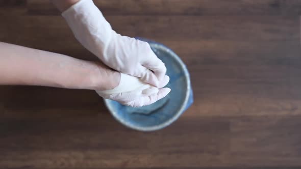 Close Up of Young Woman Removes Medical Gloves and Throw It in Trash