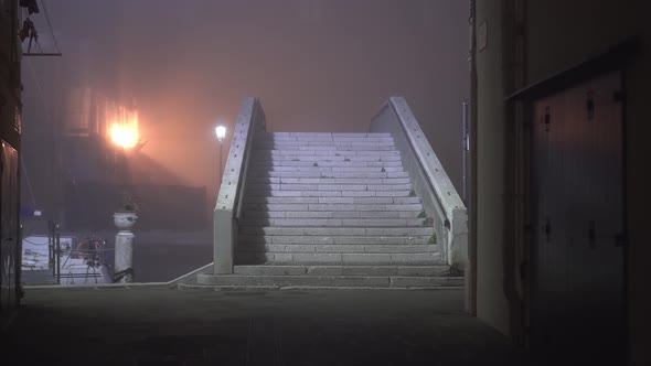 Historical Pedestrian Bridge with Stone Steps Over Channel alt