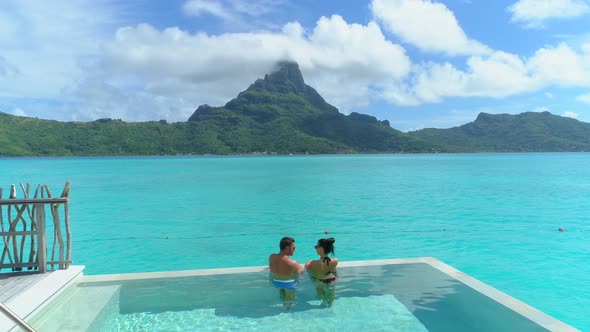 Aerial drone view of a luxury resort and overwater bungalows in Bora Bora tropical island alt