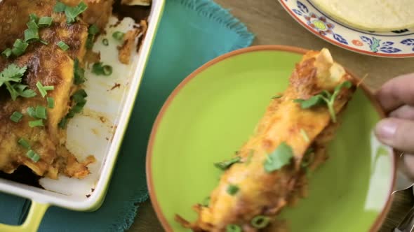 Chicken enchiladas with cheddar cheese and sauce. alt