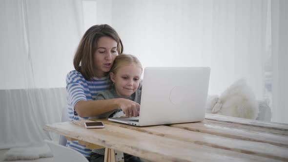 Woman is working remotely from home with child