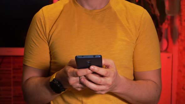 Man Texting or Browsing Online Using His Smartphone