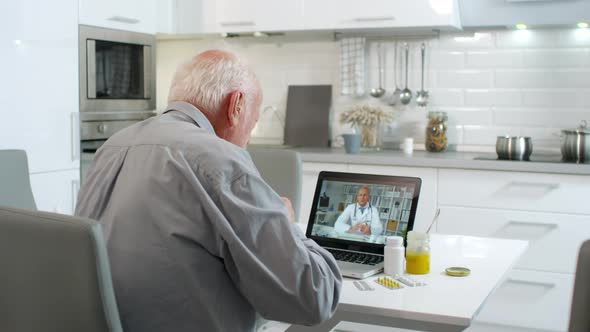 Senior Talking to Doctor by Video Link alt