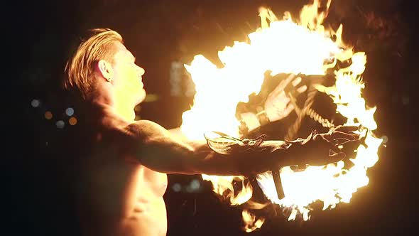 Young Blond Male Spins Two Burning Pois Tied Together Slow Motion Shot Closeup alt