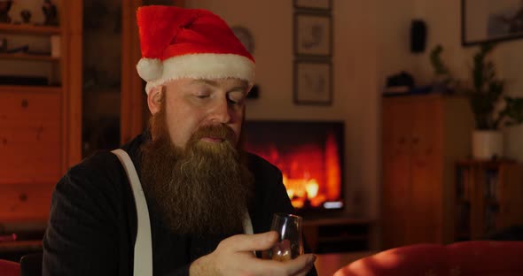 Full Bearded Man with Santa Hat Drinks