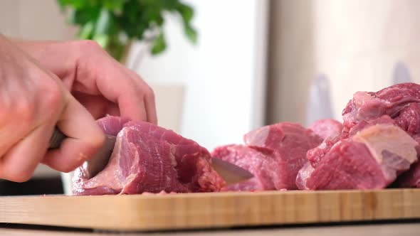 Man Cuts Meat with Knife on Wooden Board Preparation Minced Beef Pork for Cutlets Meatballs Chops