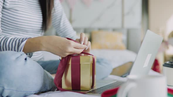 The woman received a Christmas present at home. Excited woman with Christmas Gift alt