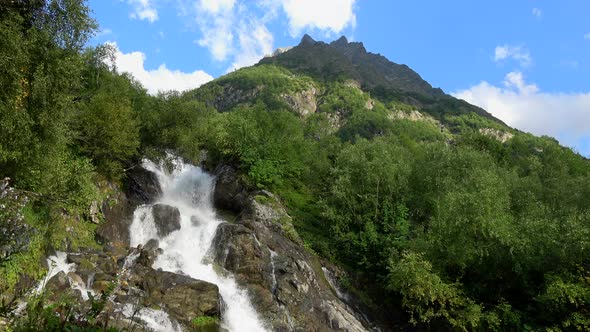 View waterfall scenes in mountains, national park Dombai, Caucasus, Russia