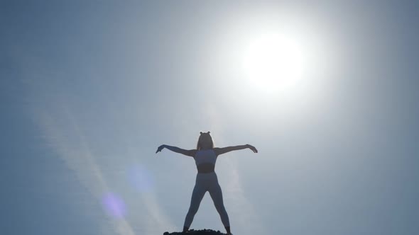 The Silhouette of the Girl in Front of the Sun. alt