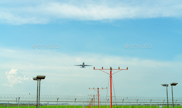Commercial airplane flying above approach light at the airport. Approach light system concept.