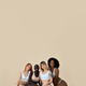 Diverse young women wear underwear sitting showing legs on beige  background. Stock Photo by insta_photos