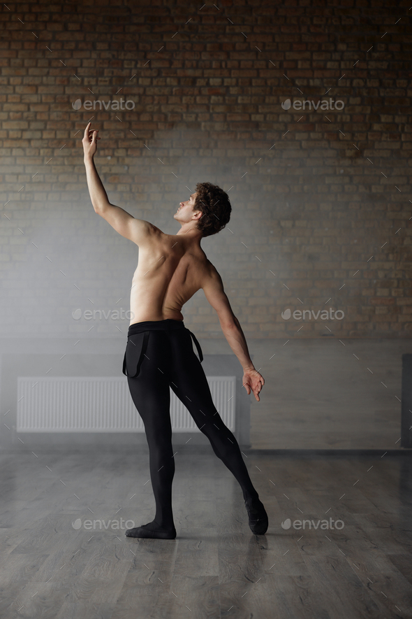 Handsome shirtless man ballet dancer making dance element