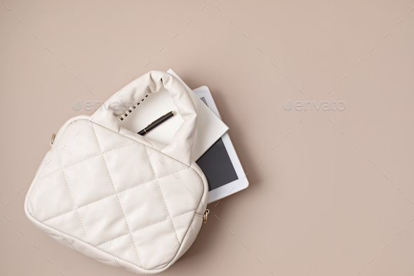 Beige quilted puffed bag on pastel background