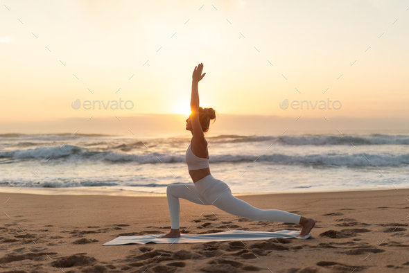 Woman practicing yoga side plank pose on the beach stock photo (237547) -  YouWorkForThem
