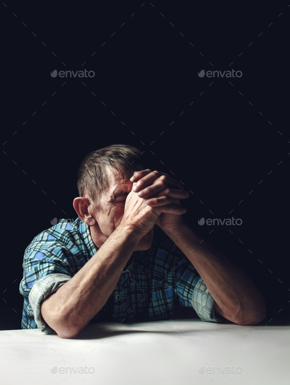 Depressed senior covers his face with his hands. Alzheimer\'s disease concept.