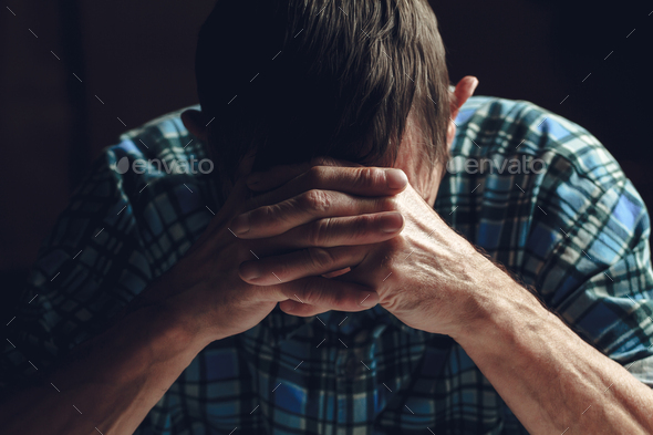 Depressed senior covers his face with his hands. Alzheimer\'s dis
