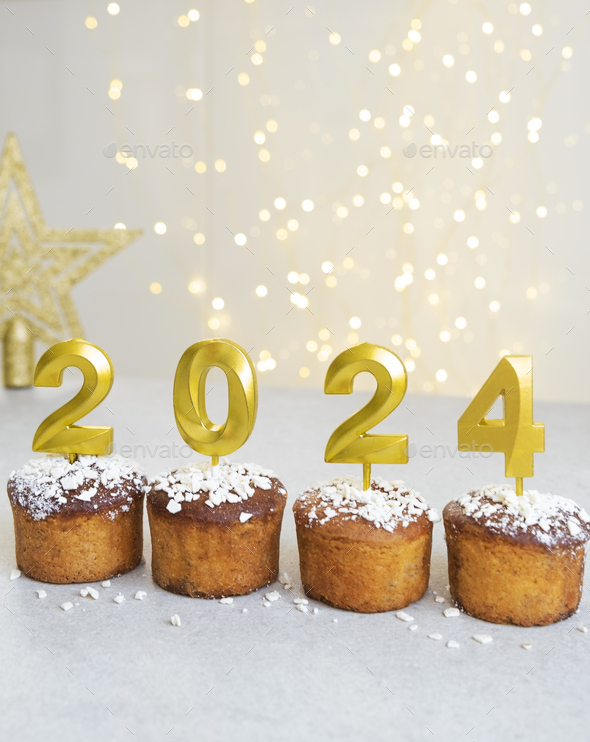 2024 number on top of cupcakes with Christmas lights Stock Photo by ta_bu