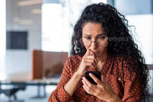 Upset and disappointed woman reading bad news close up, businesswoman inside office at workplace