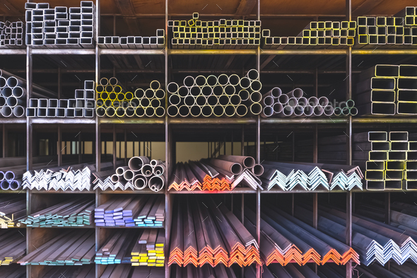 Group of various type of steel bars and pipes stacked on the storage shelf of building supply store