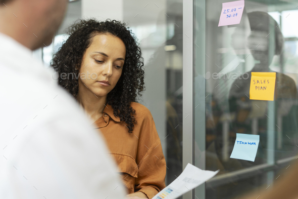 Businesswoman using sticky notes, agile methodology for productivity working in modern office