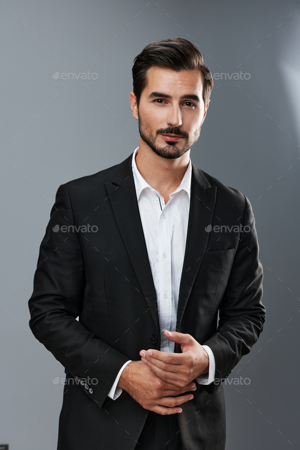 Elegant Handsome Man In Suit, Posing And Looking To Side, Standing On White  Background Stock Photo, Picture and Royalty Free Image. Image 105478990.