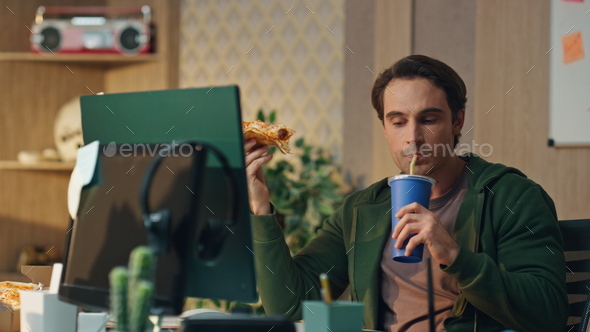 Hungry man drinking cola holding pizza office close up. Freelancer lunch break