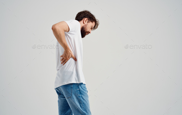 man in white t-shirt back pain osteochondrosis of the spine model back view