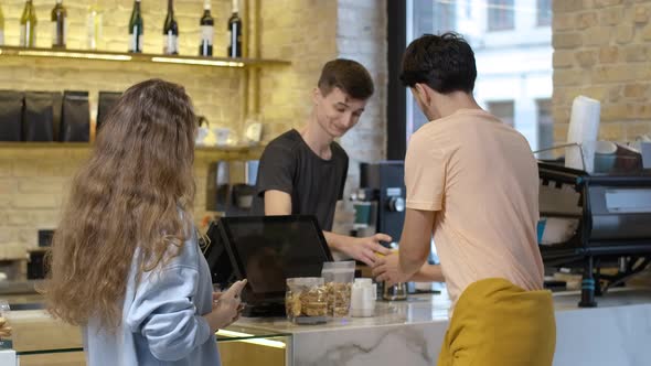 Positive Millennial Caucasian Couple Buying Coffee and Leaving alt