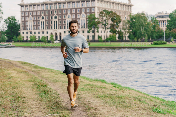 Slender figure of a man jogging. Man interval training sports lifestyle.  Stock Photo by denismuse777