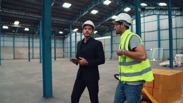 Factory Workers Deliver Boxes Package on a Pushing Trolley in the Warehouse alt