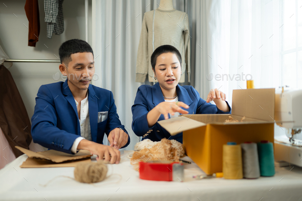 Young Asian businessman and woman Clothes are being packaged for delivery to customers