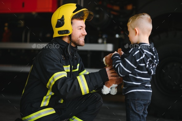 Firefighter holding child boy to save him in fire and smoke,Firemen rescue the boys from fire