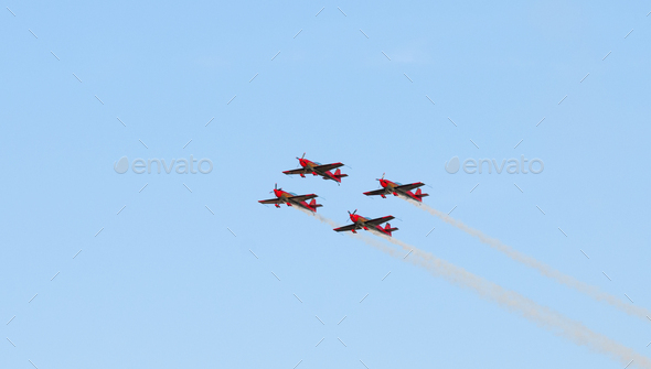 Groups of demonstration planes in synch performing aerobatics in the sky