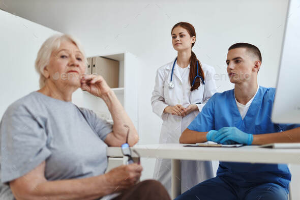 elderly woman patient in the doctor's office service assistant