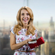 Portrait of a cheerful blonde lady taking cash from the red wallet. - PhotoDune Item for Sale