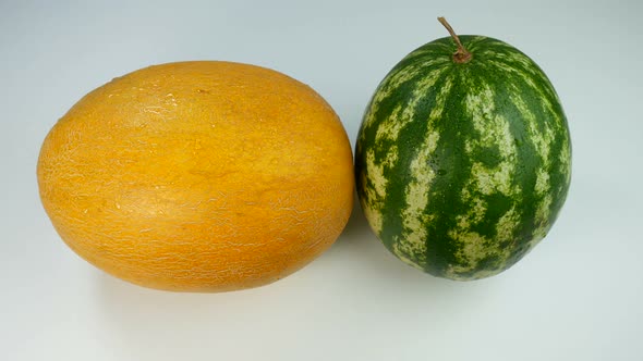 Melon And A Watermelon Covered In Water Drops