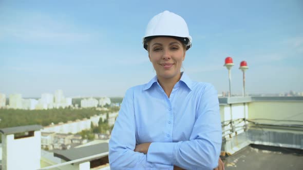 Skilled Female Engineer Helmet Crossing Arms Smiling Camera, Professional Worker