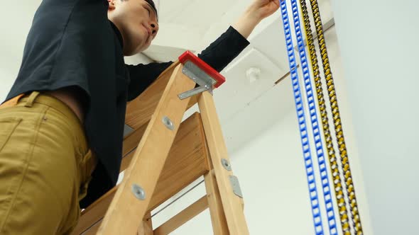 Male photographer adjusting equipment alt