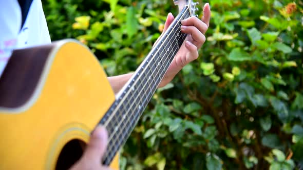 The man wear mask and playing guitar in the park 