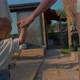Cute Blond Toddler Walks in Yard Holding Hand of Mother - VideoHive Item for Sale