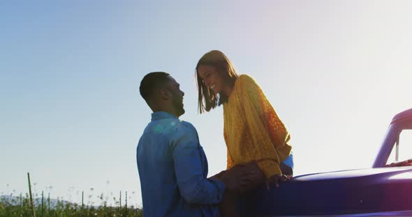 Young couple on a road trip in their pick-up truck alt