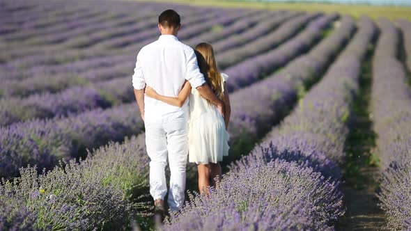 Family in Lavender Flowers Field at Sunset