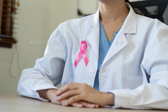 Pink October Breast Cancer Awareness month, doctor with pink ribbon symbol. National cancer