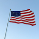 US American flag waving in the wind with a blue sky in background - PhotoDune Item for Sale