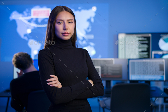 Female Cybersecurity Analyst or Manager in large Cyber Security Operations Center SOC handling