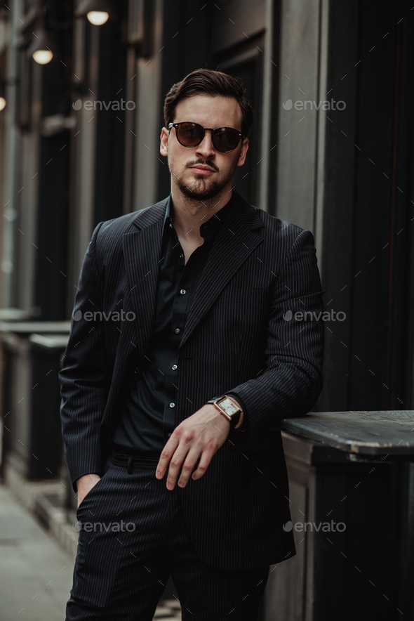 Selective Focus Photo of a Man in a Red Polo Touching His Black Sunglasses  · Free Stock Photo