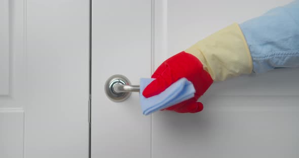 Hand Cleaning Door Handle with Antiseptic Disinfectant Wet Wipe  Low Angle Close Up alt
