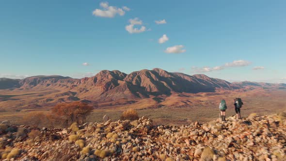 Aerial drone shot, Hikers viewing distant mountain range, Central Australia alt