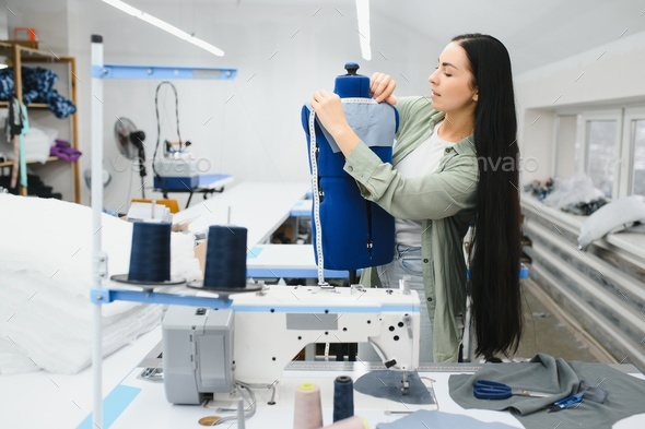 Portrait of a beautiful seamstress carrying a tape measure and