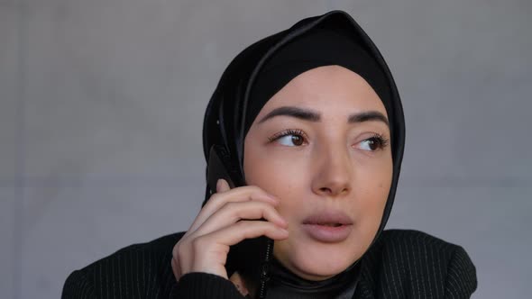 Young Muslim Business Woman in Hijab Talking on Mobile Phone